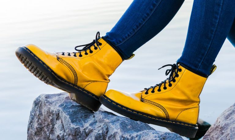 Dr Martens - two yellow and black boots on a rock