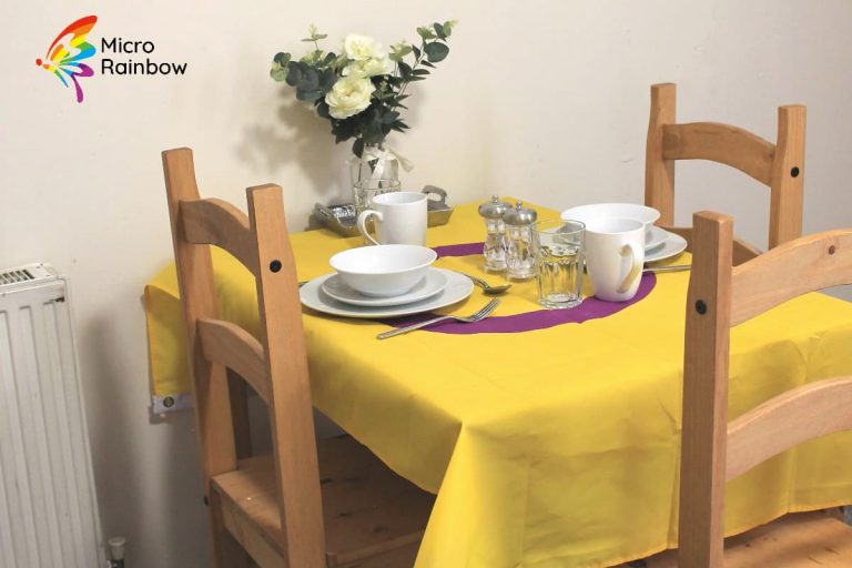 Dining table set with crockery, with a intersex flag tablecloth