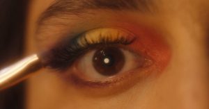 Close up of an eye, wearing rainbow eyeshadow