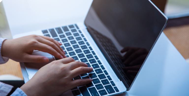 close up of hands on a laptop
